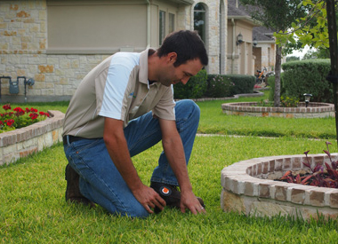 a Markham sprinkler repair tech is installing a new sprinkler head