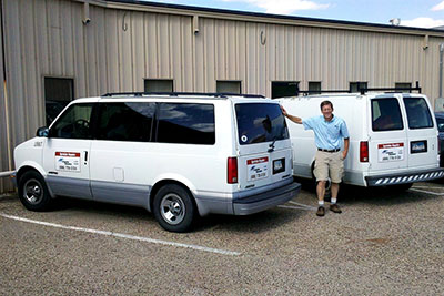 one of our Markham irrigation contractors is standing besides one of our trucks